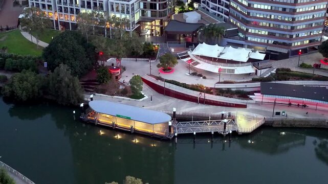 Parramatta river ferry quay in aerial sunset city view in Western Sydney, Australia.