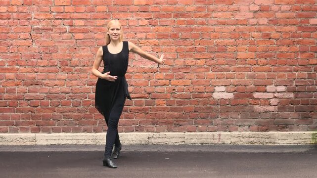 Argentine dancer walks past weathered brick wall outdoors