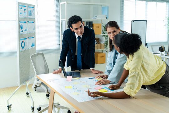 business people meeting and discussion in the office while working on a company project.Business teamwork and team doing corporate research in discussion together with technology in workplace