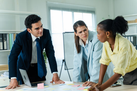 business people meeting and discussion in the office while working on a company project.Business teamwork and team doing corporate research in discussion together with technology in workplace