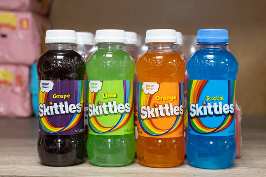 Bottles of Skittles drinks in Grape, Lime, Orange and Tropical flavors displayed together on store shelf. Kaliningrad, Russia, September 15, 2026.