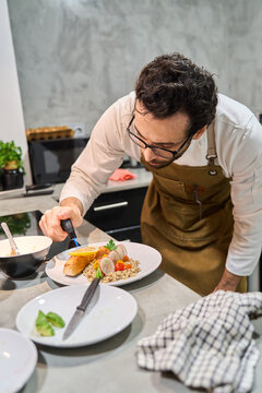 Chef torching salmon for healthy home cooking meal