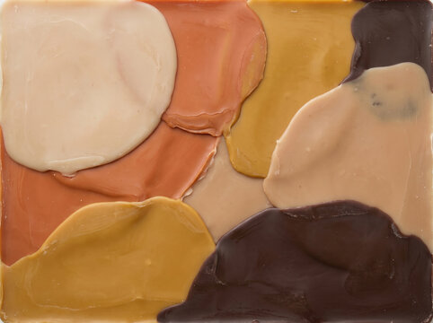 Hand poured wax texture with abstract organic shapes in warm earth tones