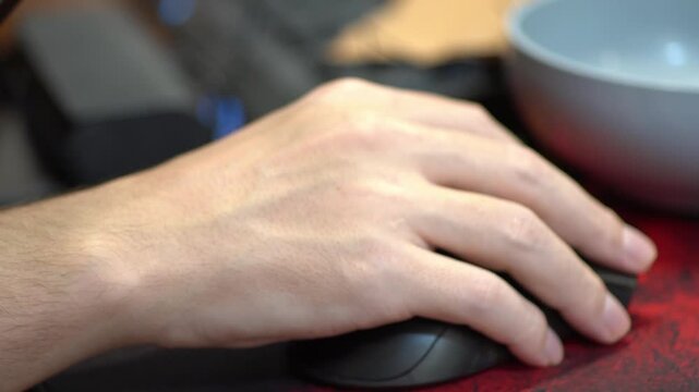 Static shot of hand moving computer mouse on office desk surface