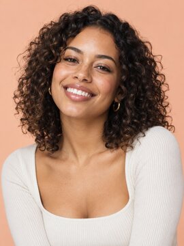 Smiling woman portrait against peach background