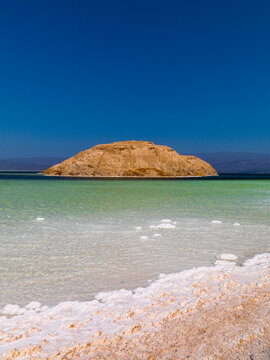 The Devil's Cauldron rock formation rises from turquoise water ringed by white salt, Dikhil Region, Lake Assal, Djibouti