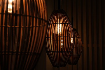 Woven Rattan Pendant Lamp with Warm Glowing Light, Handmade Bamboo Cage Lighting, Non-AI Generated, Human Made Photography © annchic