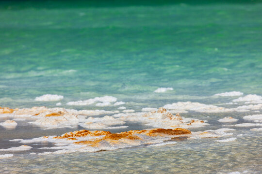 Waves deposit salt crystals along the rippling shore of Lake Assal, Dikhil Region, Lake Assal, Djibouti