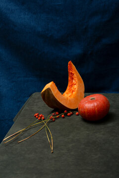 Ripe pumpkins on a table against a blue background