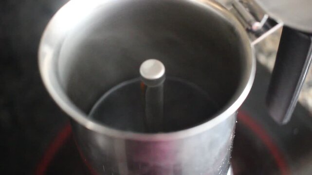 Stainless Steel Moka Pot Brewing Coffee with Steam Rising