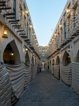 Doha, Qatar - Souq Waqif in Doha, Qatar, showcasing its traditional Qatari architecture, narrow pathways, heritage buildings, shops, and vibrant atmosphere. 