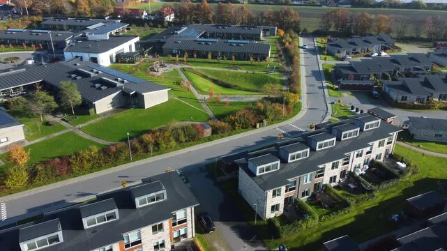 Modern row houses and curving road in Gammel Ega residential district near Aarhus, aerial