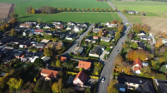 Detached homes and farmland border Gammel Ega residential neighborhood near Aarhus, aerial