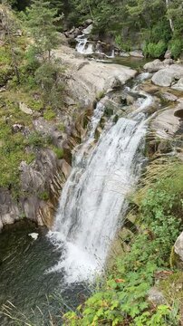 Vertical Mountain Waterfall Dropping Into Rocky Forest Pool
