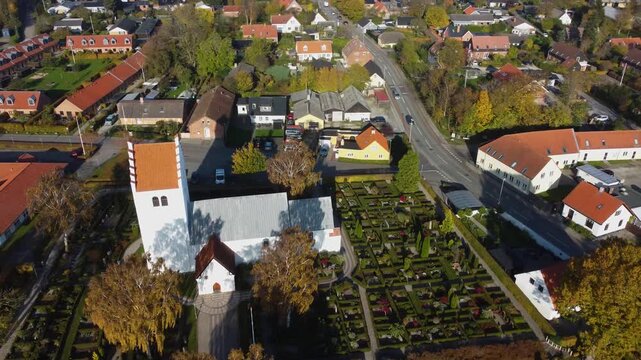 Church and surrounding homes among trees at Gammel Ega near Aarhus, Denmark, aerial