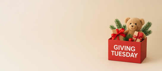 Giving Tuesday donation box with teddy bear and gifts on soft background © dvoevnore