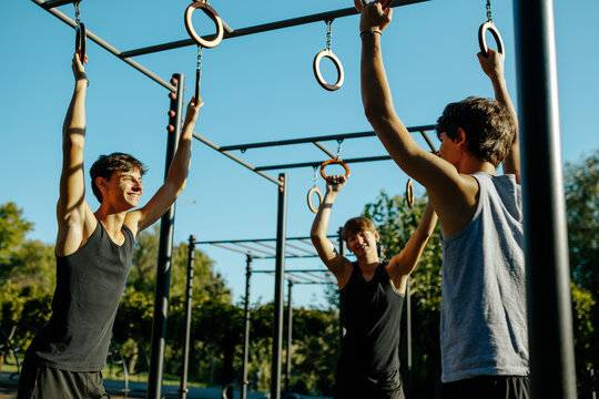 Active teen friends sharing positive energy at the outdoor sports ground.