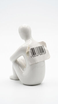 White Human Figurine With Barcode On Back Kneeling Alone