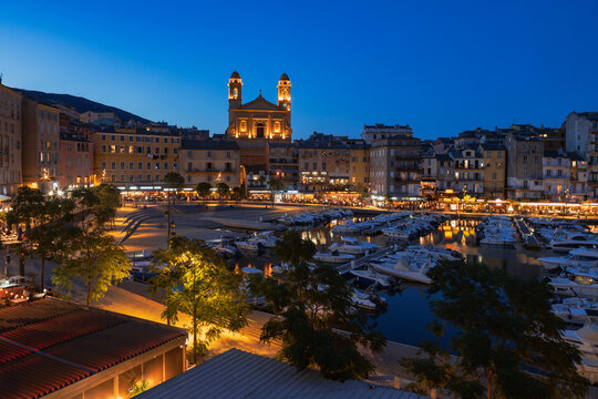 Old Port of bastia with church and boats at dusk in corsica