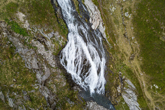 Alpine wilderness and nature conservation, aerial drone view of a mountain waterfall cascading through rocks in the Kitzb&uuml;hel Alps of Austria