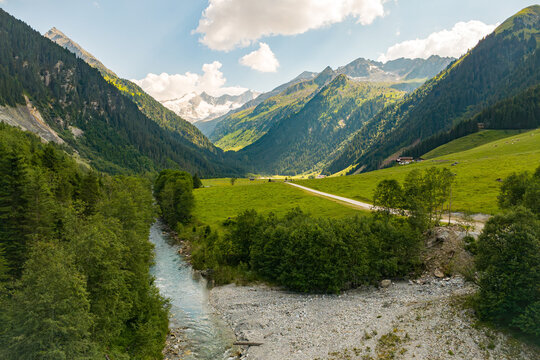 Alpine wilderness and nature conservation, aerial view of a mountain stream in the Kitzb&uuml;hel Alps in Austria with lush green meadows and summer landscape