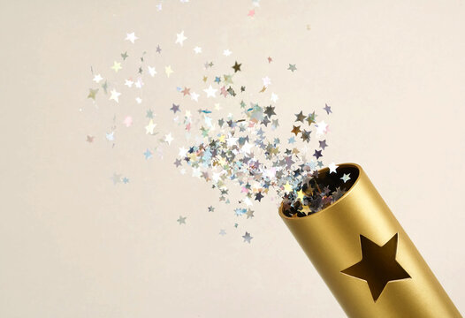 Golden star confetti dispenser releasing colorful sparkles in air