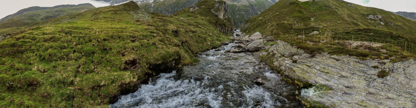 Alpine wilderness and mountain stream in the Kitzb&uuml;hel Alps, scenic aerial view of pristine nature and flowing water in Hohe Tauern National Park in austria