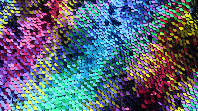 Iridescent sequin fabric texture background, colorful sparkling sequins pattern for glamour party, fashion or festive design