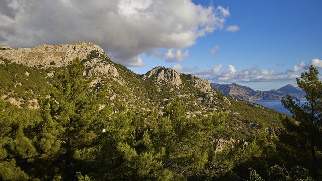 Panorama with mountains and clouds in the blue sky, morning light, sunrise, coastal road, east coast, Karpathos, Dodecanese, Greek Islands, Greece