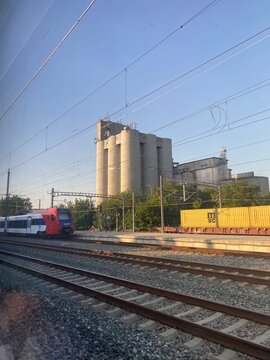 Regional passenger train stands on the tracks next to the concrete silos of the Zitosrem grain elevator in Sid, Serbia on August 3, 2026
