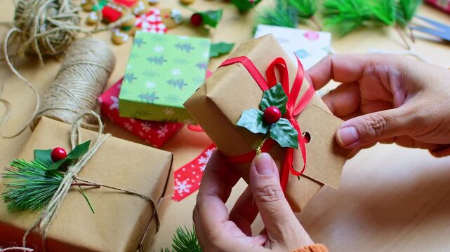 Woman's hands wrapping a christmas gift box