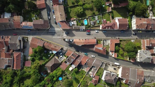 Aerial View of a Bustling Street and Rooftops in Saint Mihiel, France, with Moving Cars