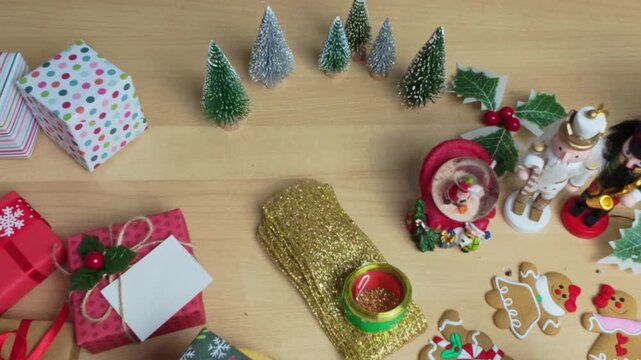 Christmas decorations and presents arranged on wooden background