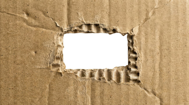 A rectangular hole torn through the center of a piece of brown corrugated cardboard isolated on transparent background