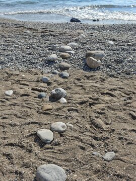 Pebble path leading to ocean on rocky beach