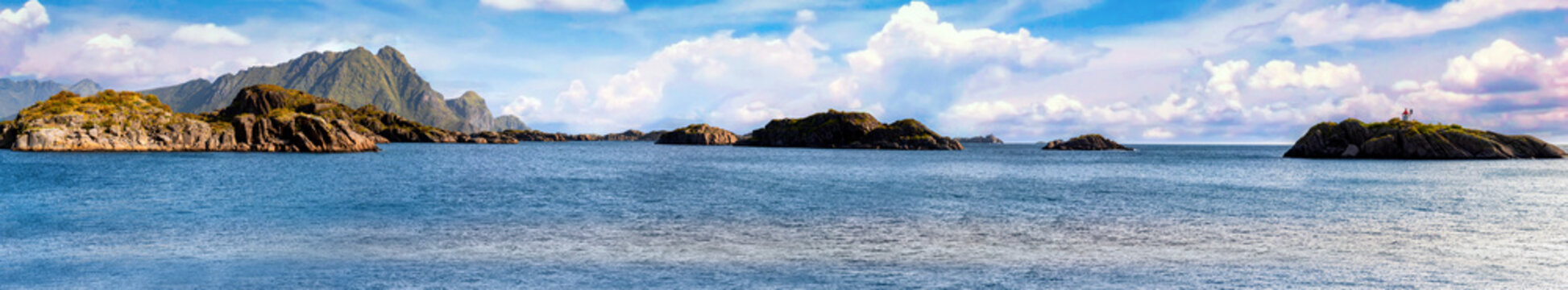 Panoramic view from the end of Ureveien across rocky islands and the Vestfjord near Ure on Vestvagoya, with mountains, blue sea and expansive sky.