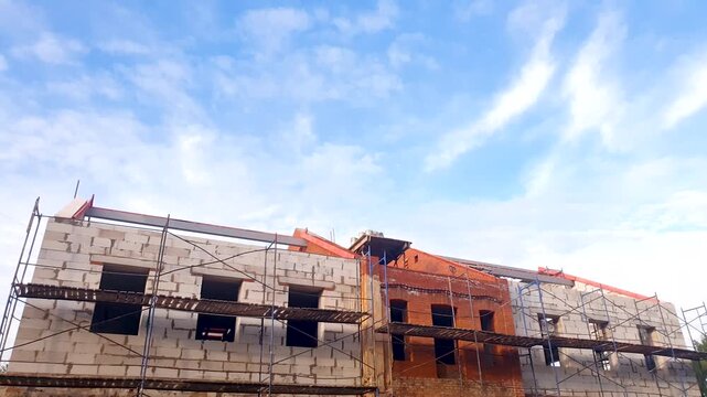 Renovation and restoration of the exterior appearance of buildings using scaffolding. Improvement of the exterior appearance of a city building