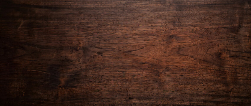 Moody walnut wood grain texture background showing dark rich brown timber surface with natural knots for luxury design use