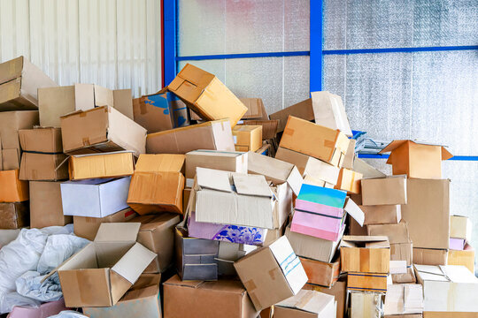 Stack of Cardboard Boxes in a Warehouse, Large pile of used cardboard boxes stacked in a storage area, packaging waste, paper recycling, waste sorting and sustainable resource management
