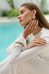 Elegant profile portrait of woman wearing white resort fashion © Yevhenii