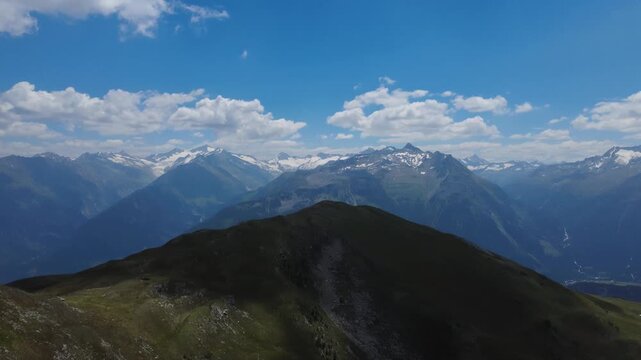 Alpine mountain panorama in the Kitzb&uuml;hel Alps: an aerial drone pan shot of rugged peaks and ridgelines in the Hohe Tauern National Park, austria