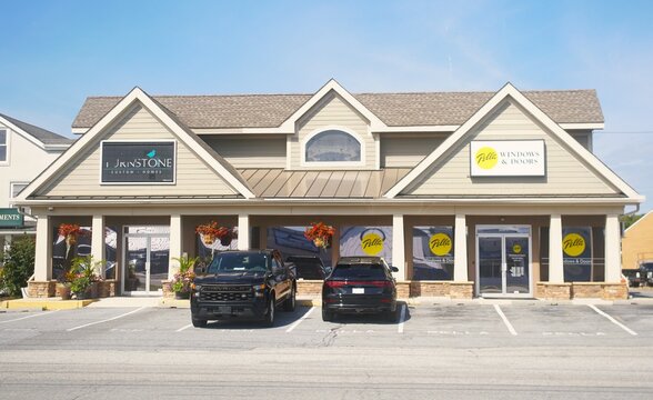 Rehoboth Beach, Delaware, U.S.A - Sep 9, 2026 - Commercial building housing Turnstone Custom Homes and Pella Windows & Doors with parking and decorative plants.