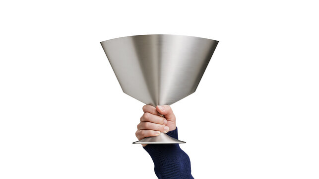 Isolated person's hand in blue sweater holding up a modern metallic geometric trophy, celebrating achievement