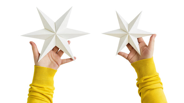 Isolated hands holding two beautiful white paper stars, symbolizing holiday season joy and craftsmanship.