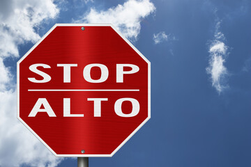 Red stop Alto Spanish sign with sky © Karen Roach