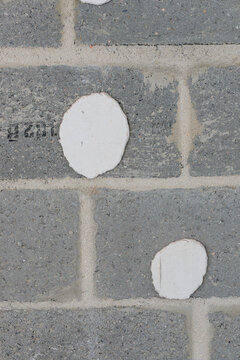 Blockwork wall with dabs of plaster adhesive