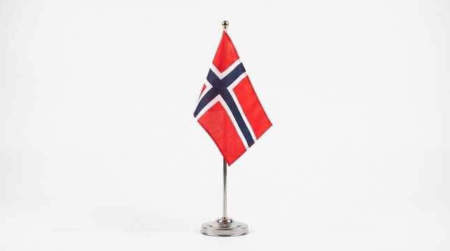 A small desk flag of norway featuring the red white and blue nordic cross design standing on a metal pole isolated against