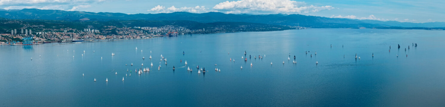 Wide aerial panorama of a sailing regatta on the calm waters of Kvarner Bay near Rijeka, Croatia