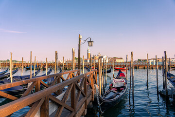 Venetian gondolas with San Giorgio Maggiore across the Venice Lagoon, Italy © Bernadett