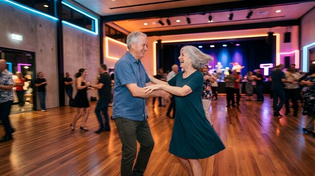 Happy mature couple dancing together in a lively modern ballroom venue